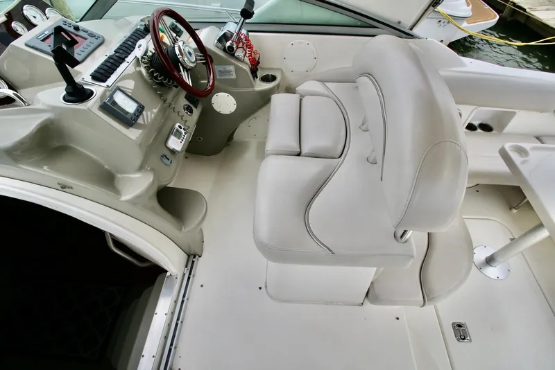 Slide: The Image of 2009 Larson Cabrio 310 boat interior with steering wheel and control panel. - 16