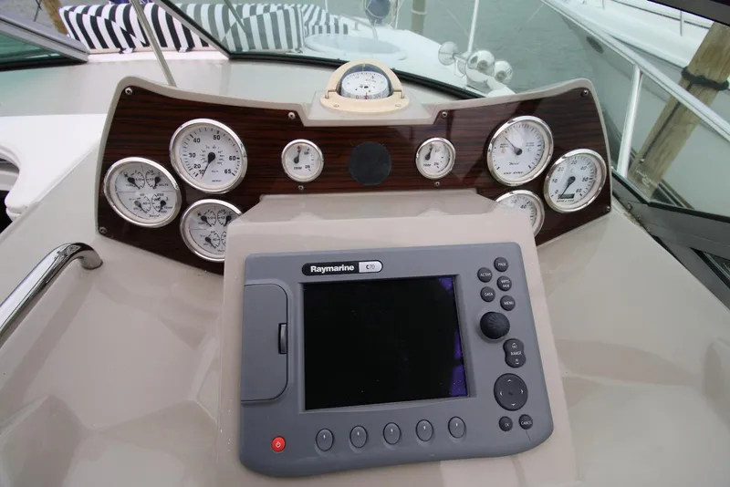 Slide: The Image of Dashboard of 2009 Larson Cabrio 310 boat with gauges and Raymarine navigation system. - 17