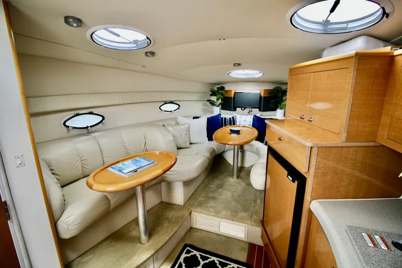 Slide: The Image of Luxurious interior of a 2009 Larson Cabrio 310 yacht with plush seating and elegant decor. - 19