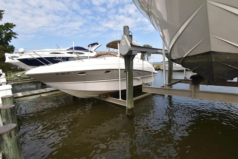 Slide: The Image of 2009 Larson Cabrio 310 boat docked at marina. - 2