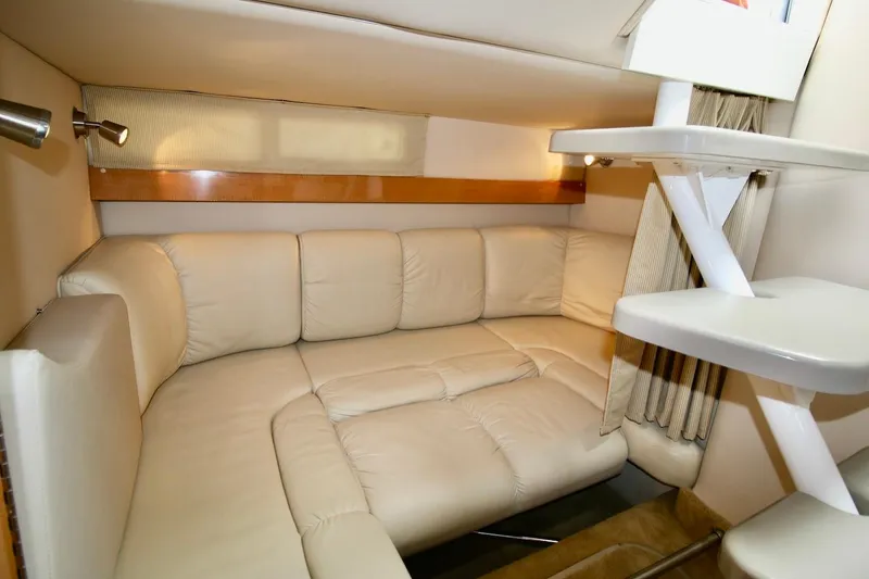 Slide: The Image of Interior of 2009 Larson Cabrio 310 yacht with plush beige seating and modern lighting. - 24