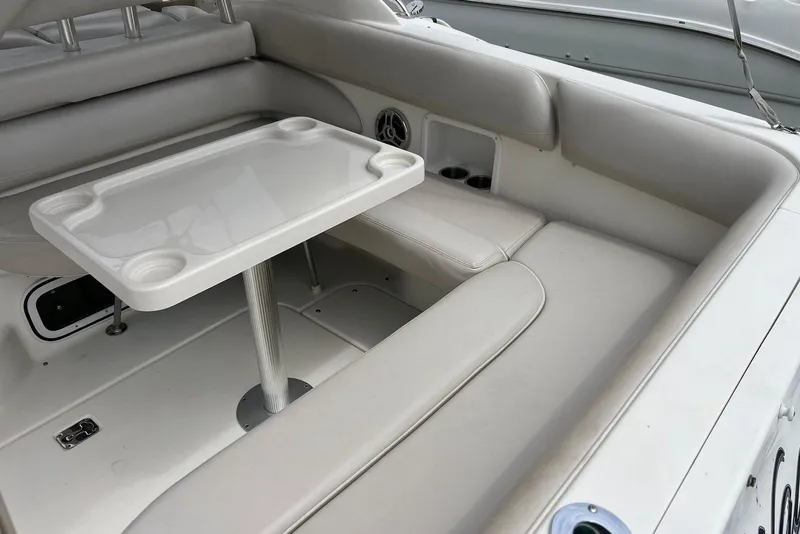 Slide: The Image of 2009 Larson Cabrio 310 boat interior with white seating and table. - 25