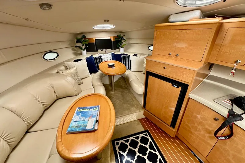 Slide: The Image of Luxurious interior of 2009 Larson Cabrio 310 yacht with plush seating and wooden cabinetry. - 29