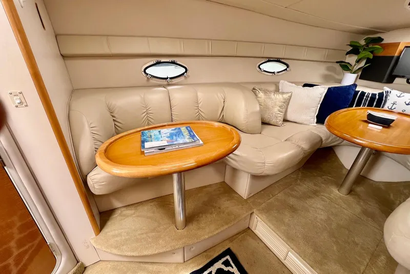 Slide: The Image of Luxurious interior of 2009 Larson Cabrio 310 yacht with plush seating and wooden tables. - 31