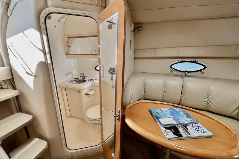 Slide: The Image of Interior of 2009 Larson Cabrio 310 boat with cozy seating and compact bathroom. - 33