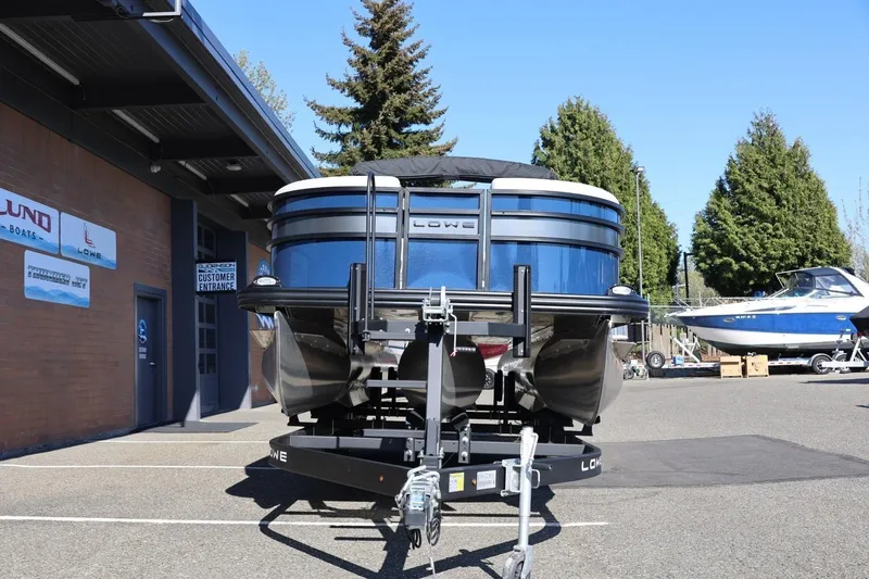 Slide: The Image of 2026 Lowe SS 230 CL pontoon boat on trailer at dealership. - 13