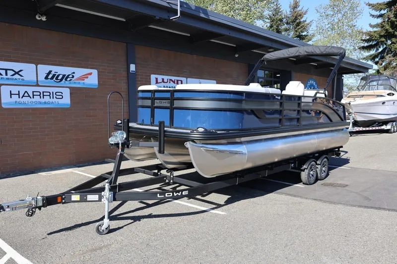 Slide: The Image of 2026 Lowe SS 230 CL pontoon boat on trailer outside dealership. - 14