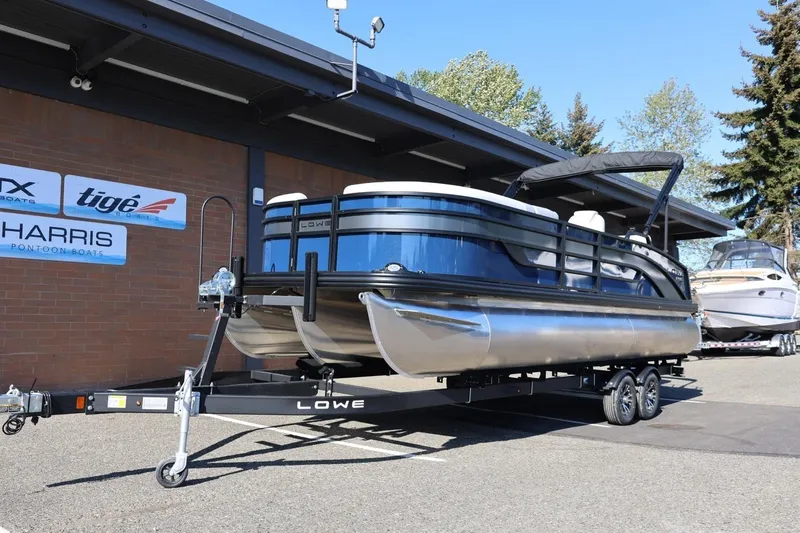 Slide: The Image of 2026 Lowe SS 230 CL pontoon boat on trailer outside dealership. - 15