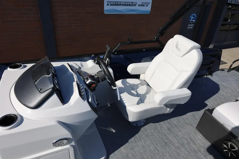 Slide: The Image of 2026 Lowe SS 230 CL boat interior with white captain's chair and steering console. - 24