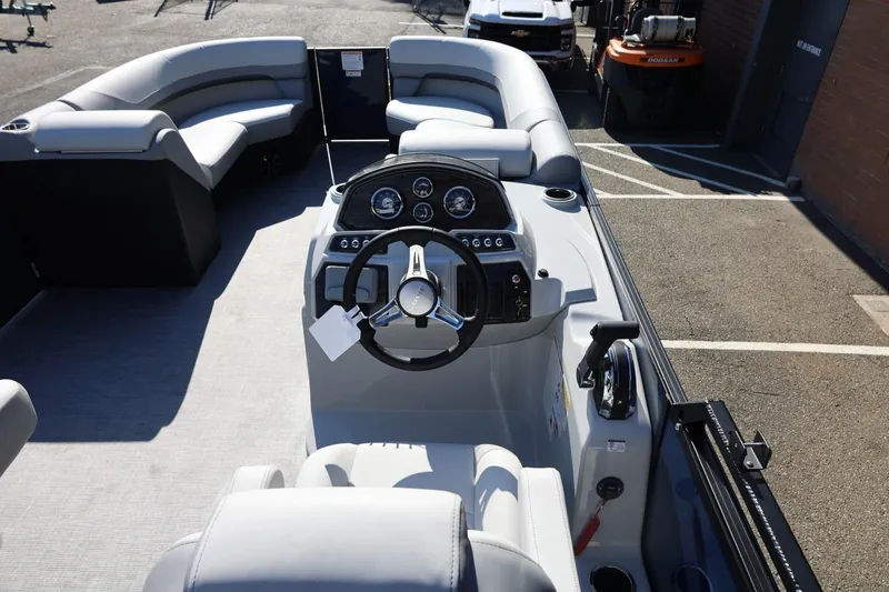 Slide: The Image of 2026 Lowe SS 230 CL boat interior with steering console and seating arrangement. - 25