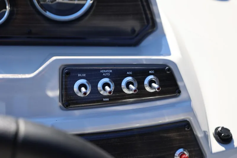 Slide: The Image of Control panel of 2026 Lowe SS 230 CL boat with switches for bilge and aerator. - 28