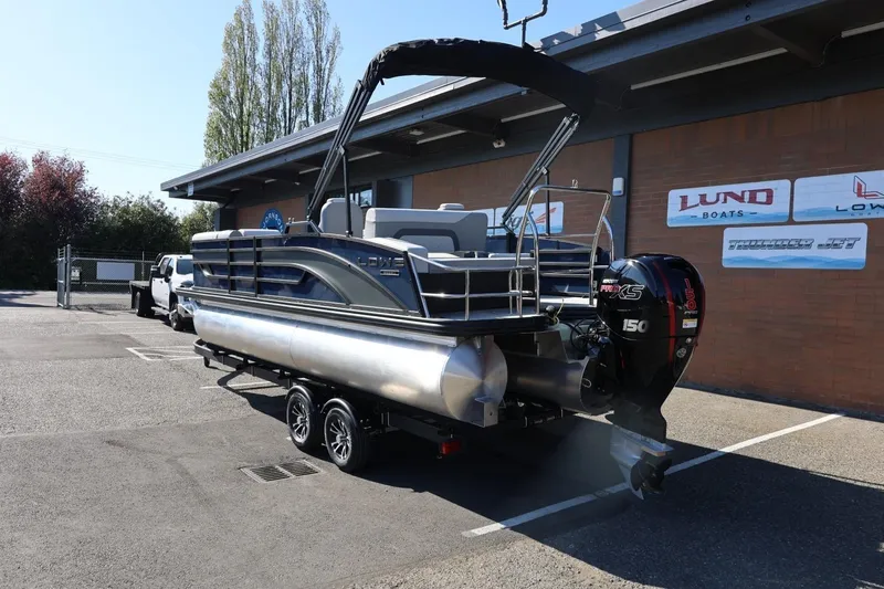 Slide: The Image of 2026 Lowe SS 230 CL pontoon boat on trailer, parked outside dealership. - 3