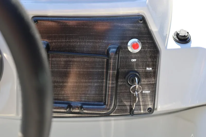 Slide: The Image of Control panel of 2026 Lowe SS 230 CL boat with ignition key and start button. - 31