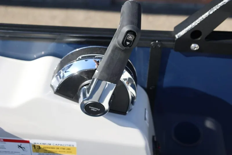 Slide: The Image of Throttle control lever on a 2026 Lowe SS 230 CL boat dashboard. - 32