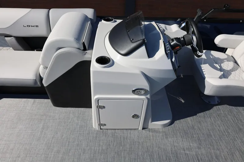 Slide: The Image of 2026 Lowe SS 230 CL boat interior with steering console and seating. - 33