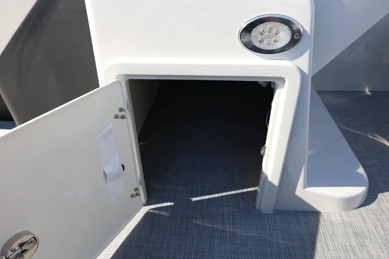 Slide: The Image of Open storage compartment on 2026 Lowe SS 230 CL boat with LED light. - 34