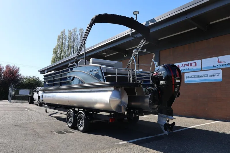 Slide: The Image of 2026 Lowe SS 230 CL pontoon boat with outboard motor on trailer. - 4