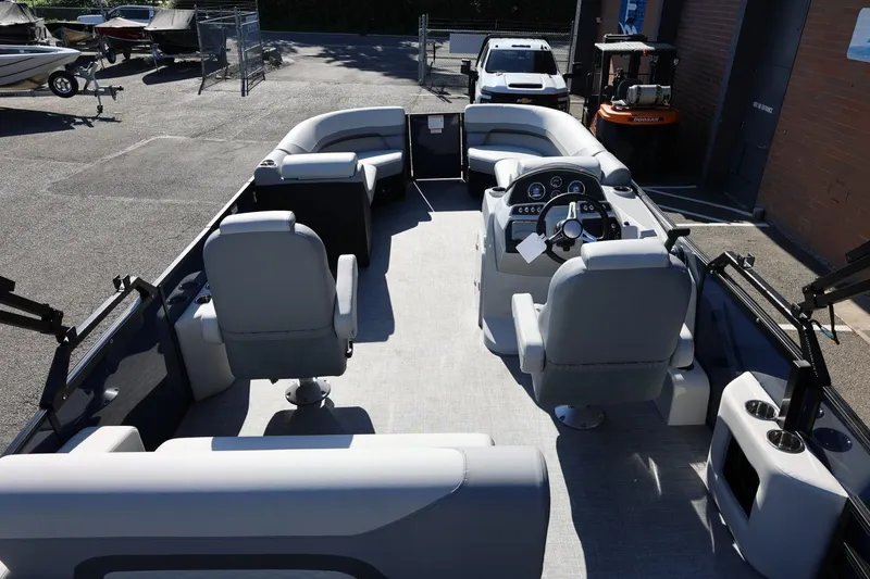 Slide: The Image of 2026 Lowe SS 230 CL pontoon boat interior with helm and seating arrangement. - 44