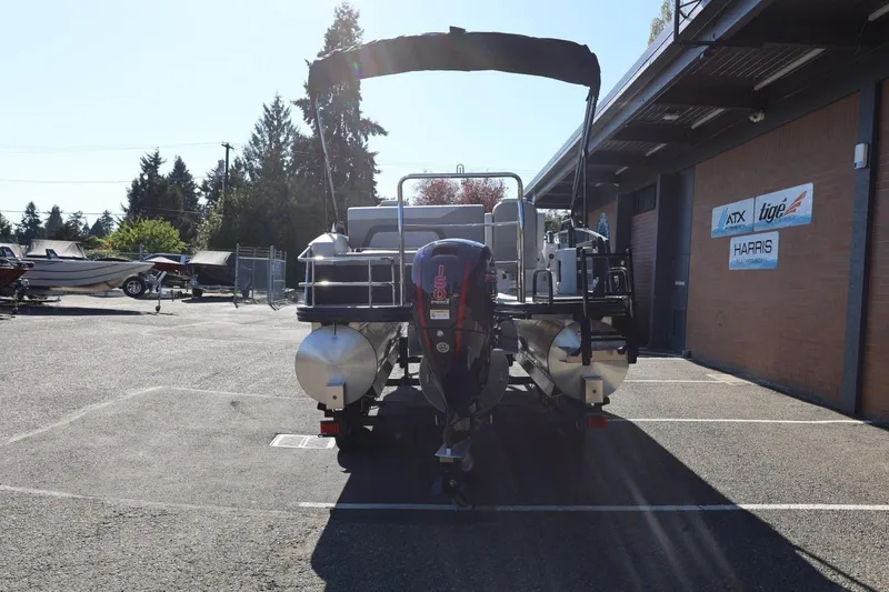 Slide: The Image of 2026 Lowe SS 230 CL pontoon boat parked outside dealership. - 5