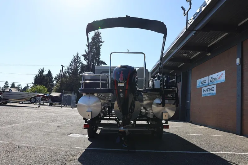 Slide: The Image of 2026 Lowe SS 230 CL pontoon boat parked outside dealership. - 6