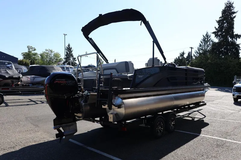 Slide: The Image of 2026 Lowe SS 230 CL pontoon boat on trailer in parking lot. - 7