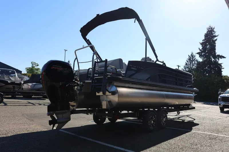 Slide: The Image of 2026 Lowe SS 230 CL pontoon boat on trailer in parking lot. - 8