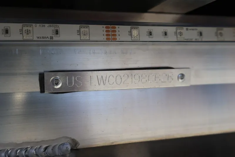 Slide: The Image of Serial number plate on Lowe SS 230 CL, 2026 model, with LED strip above. - 9