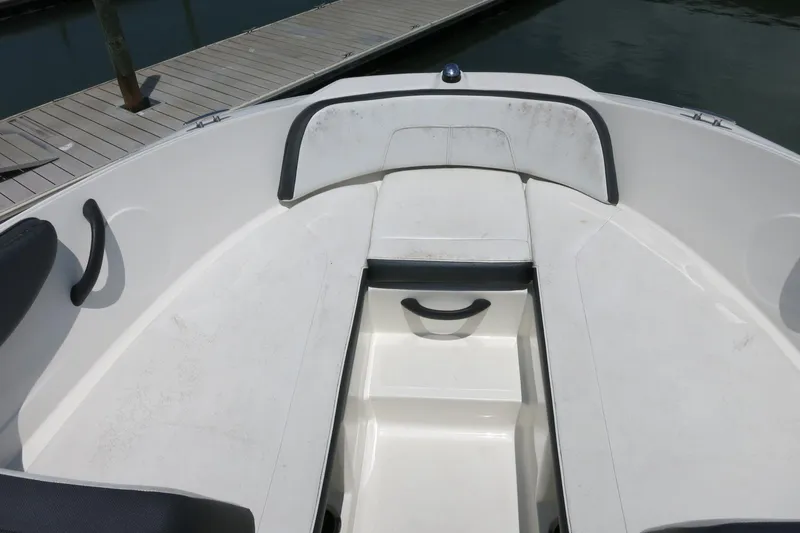 Slide: The Image of 2017 Sea Ray SPX 190 Outboard boat interior, featuring white seating and storage compartment. - 15