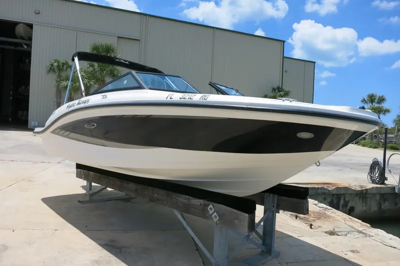 Slide: The Image of 2017 Sea Ray SPX 190 Outboard boat on a dock under a clear blue sky. - 2