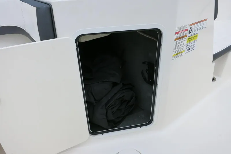 Slide: The Image of Open storage compartment on a 2017 Sea Ray SPX 190 Outboard boat. - 24