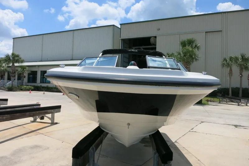 Slide: The Image of 2017 Sea Ray SPX 190 Outboard boat displayed outdoors near a warehouse. - 3
