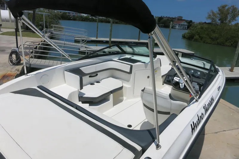 Slide: The Image of 2017 Sea Ray SPX 190 Outboard boat docked, featuring spacious seating and sleek design. - 7