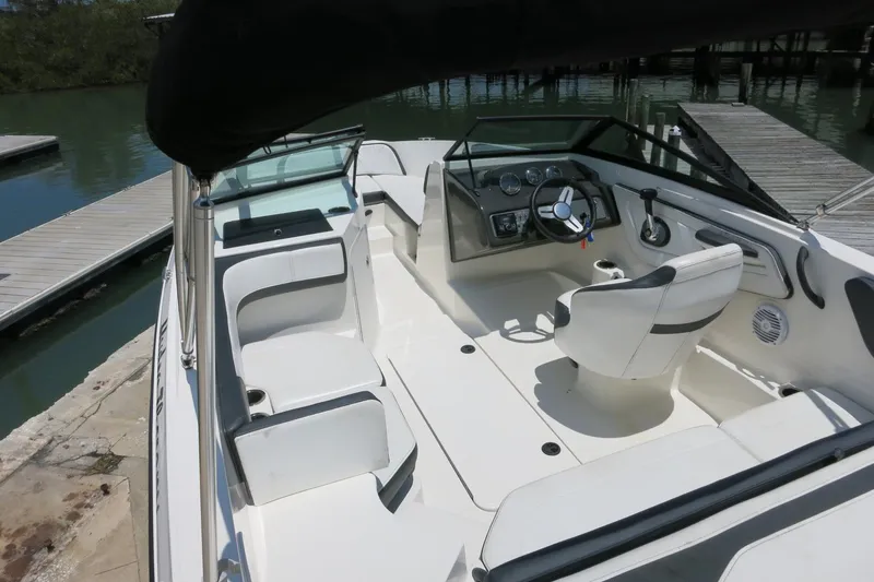 Slide: The Image of 2017 Sea Ray SPX 190 Outboard boat interior with seating and steering wheel at dock. - 9