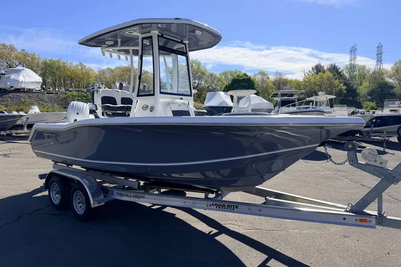The Image of 2026 Tidewater 210 CC Adventure boat on trailer, parked outdoors under clear sky. - 0