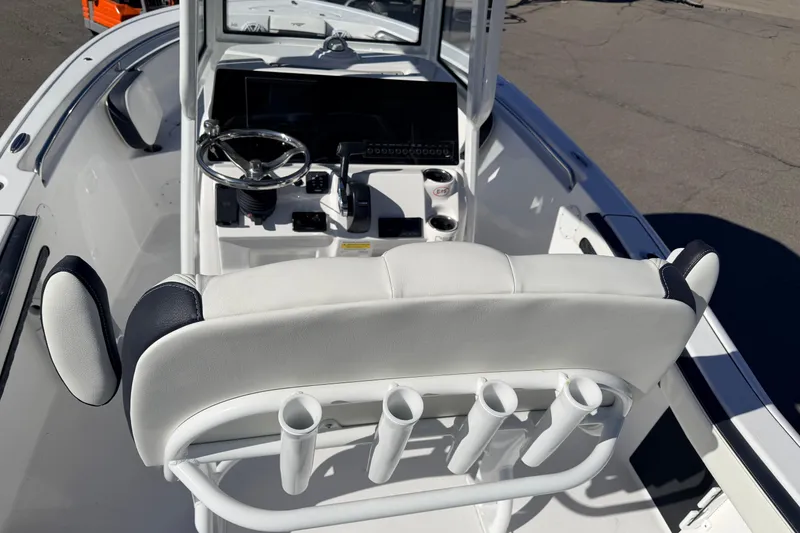 Slide: The Image of 2026 Tidewater 210 CC Adventure boat interior with steering console and rod holders. - 10