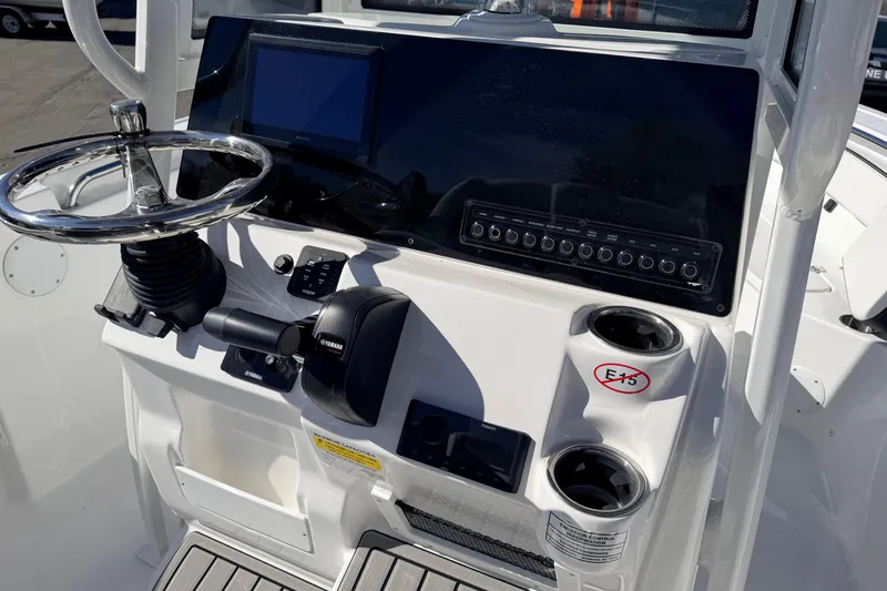 Slide: The Image of 2026 Tidewater 210 CC Adventure boat dashboard with steering wheel and controls. - 17
