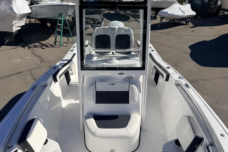 Slide: The Image of 2026 Tidewater 210 CC Adventure boat interior with seating and console view. - 20