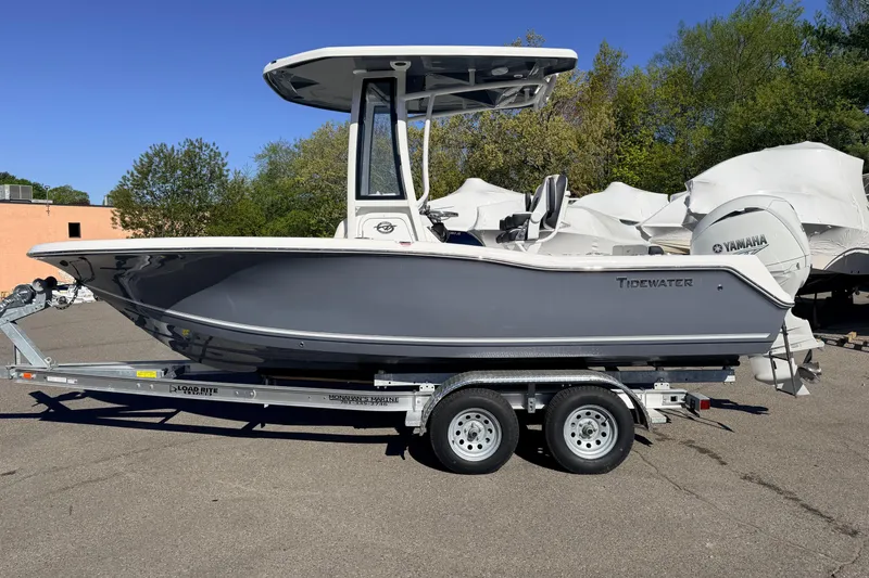 Slide: The Image of 2026 Tidewater 210 CC Adventure boat on trailer, side view, outdoors. - 3
