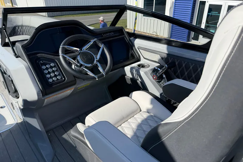 Slide: The Image of Interior view of 2024 Godfrey Sanpan 2500 DFLW boat cockpit with steering wheel and controls. - 10