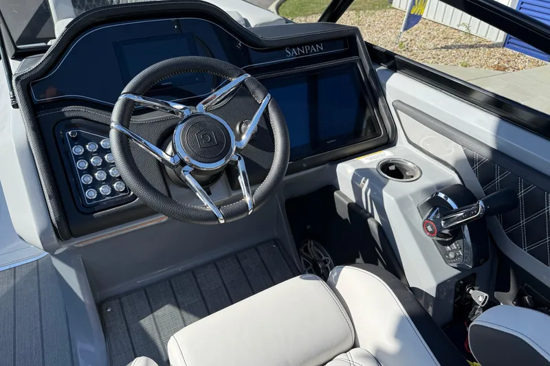 Slide: The Image of 2024 Godfrey Sanpan 2500 DFLW boat dashboard with steering wheel and controls. - 11