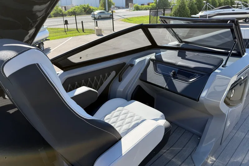 Slide: The Image of 2024 Godfrey Sanpan 2500 DFLW boat interior with sleek seating and modern dashboard design. - 12