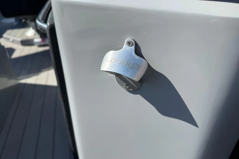 Slide: The Image of 2024 Godfrey Sanpan 2500 DFLW boat with branded bottle opener. - 14