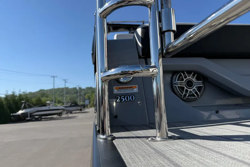 Slide: The Image of 2024 Godfrey Sanpan 2500 DFLW boat ladder and speaker detail under clear blue sky. - 19
