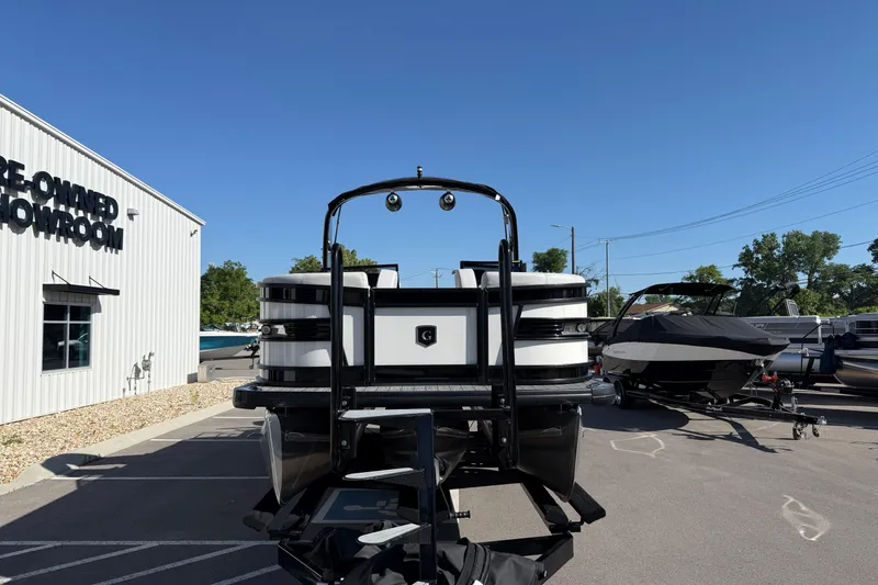 Slide: The Image of 2024 Godfrey Sanpan 2500 DFLW pontoon boat at pre-owned showroom. - 2