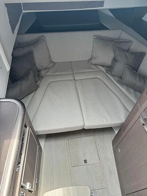 Slide: The Image of 2024 Galeon 325 GTO cabin interior with beige cushions and pillows. - 18