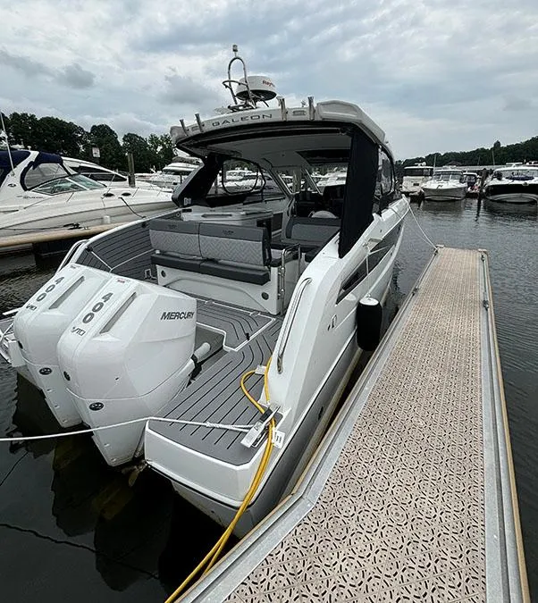 Slide: The Image of 2024 Galeon 325 GTO luxury yacht docked, featuring twin Mercury outboard engines. - 4