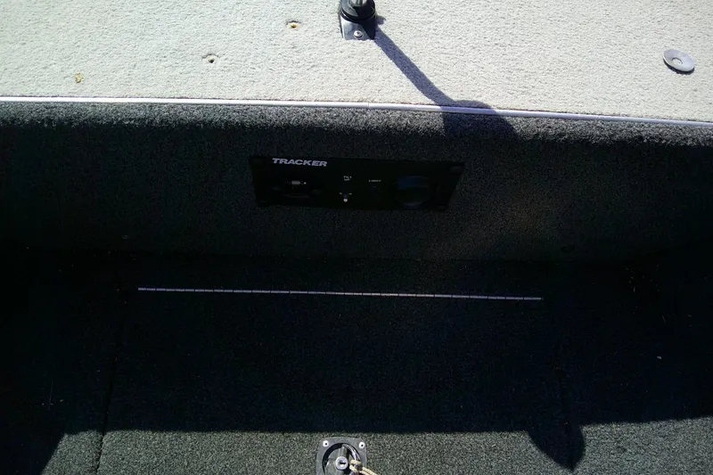Slide: The Image of 1989 Bass Tracker Pro Deep V-17 boat interior with control panel. - 11