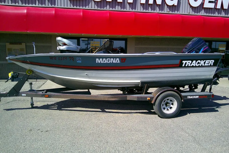 Slide: The Image of 1989 Bass Tracker Pro Deep V-17 boat on trailer outside a sporting center. - 2