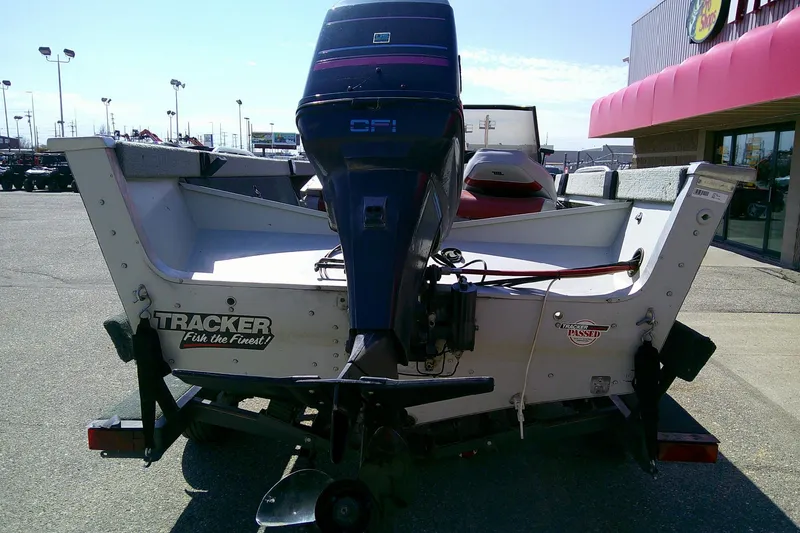 Slide: The Image of 1989 Bass Tracker Pro Deep V-17 boat with outboard motor in parking lot. - 3