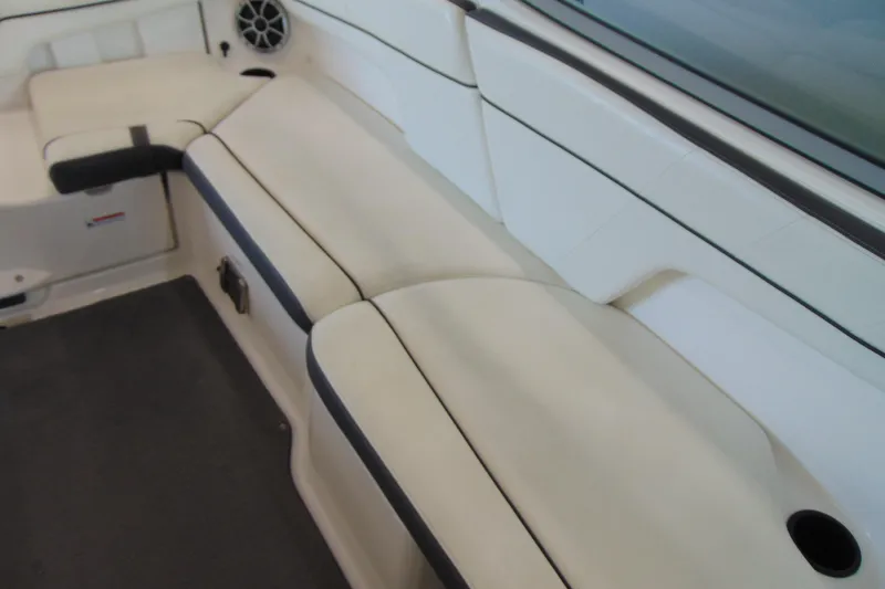 Slide: The Image of 2014 Yamaha AR210 boat interior with white cushioned seating and speaker. - 13